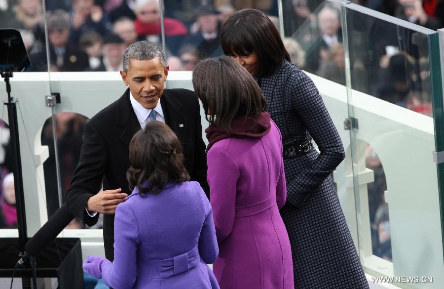 U.S. President Barack Obama (L) talks to his wife and daughters after he was sworn in for his second term during the presidential inauguration ceremony on the West Front of the U.S. Capitol in Washington D.C., the United States, on Jan. 21, 2013. (Xinhua/Fang Zhe) 