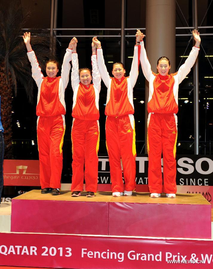Team China poses on the podium during the awarding ceremony for the women's epee team final at the Fencing Grand Prix and World Cup in Doha, Jan. 21, 2013. Team China defeated team Estonia to claim the title. (Xinhua/Chen Shaojin) 