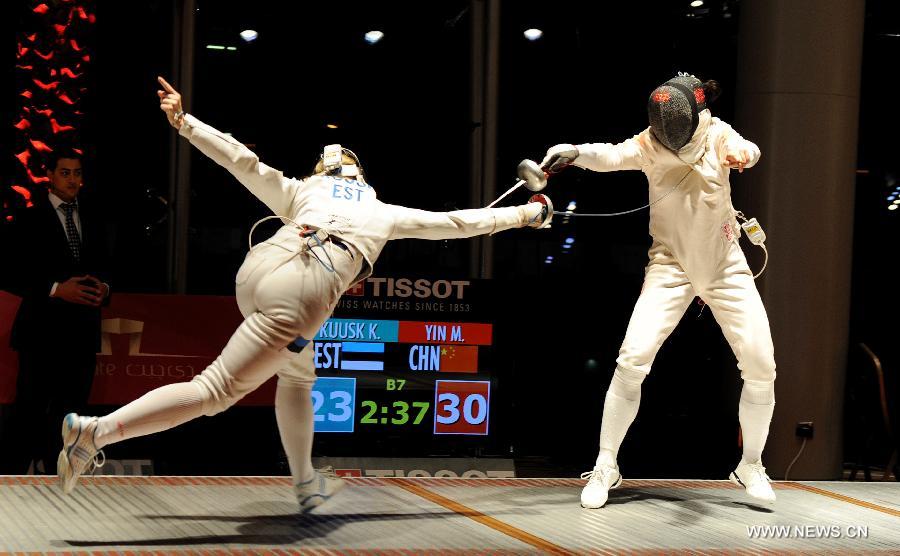 Kristina Kuusk (L) of Estonia competes during the women's epee team final between Estonia and China at the Fencing Grand Prix and World Cup in Doha, Jan. 21, 2013. (Xinhua/Chen Shaojin) 