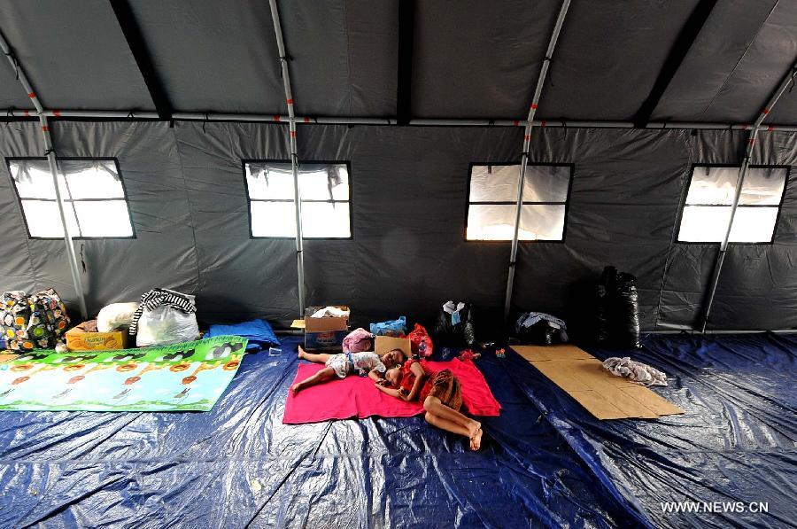 Children rest at a refugee camp in Otista, Jakarta, Indonesia, Jan. 21, 2013. Indonesia Health Minister Nafsiah Mboi underlined on Monday the importance of greater attention to flood victims, especially women and children coping with the current hardship in Jakarta. (Xinhua/Agung Kuncahya B.)