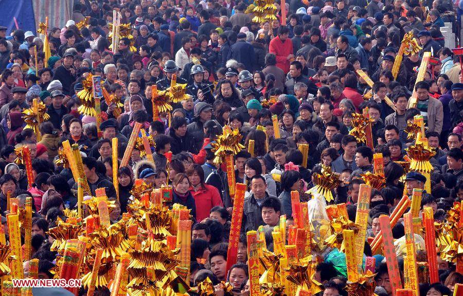 File photo taken on March 17, 2010 shows people swarm into a temple fair in Huaiyang County, central China's Henan Province. Temple fair in central China area is an important social activity for local people. The ancient temple fairs in central China were ceremonious sacrificial rituals. As time goes by, the focus of temple fair activities has shifted from "gods" to "people". The modern temple fair in central China is a platform of displaying folk culture as well as a channel for commodity circulation. According to statistics from the provincial cultural sector, there are about 35,000 temple fairs each year in Henan. (Xinhua/Wang Song)