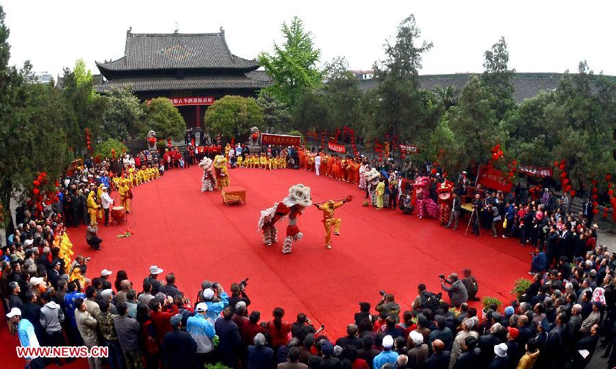File photo taken on April 12, 2012 shows lion dance performance at a temple fair in Luoyang City, central China's Henan Province. Temple fair in central China area is an important social activity for local people. The ancient temple fairs in central China were ceremonious sacrificial rituals. As time goes by, the focus of temple fair activities has shifted from "gods" to "people". The modern temple fair in central China is a platform of displaying folk culture as well as a channel for commodity circulation. According to statistics from the provincial cultural sector, there are about 35,000 temple fairs each year in Henan. (Xinhua/Wang Song)