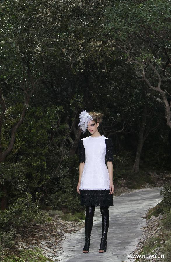 A model presents a creation by German designer Karl Lagerfeld for French fashion house Chanel during the Haute Couture Spring-Summer 2013 collection shows in Paris, France, Jan. 22, 2013. (Xinhua/Gao Jing) 