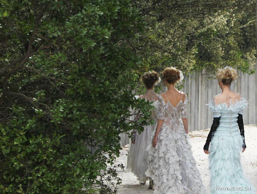 Models present creations by German designer Karl Lagerfeld for French fashion house Chanel during the Haute Couture Spring-Summer 2013 collection shows in Paris, France, Jan. 22, 2013. (Xinhua/Gao Jing) 