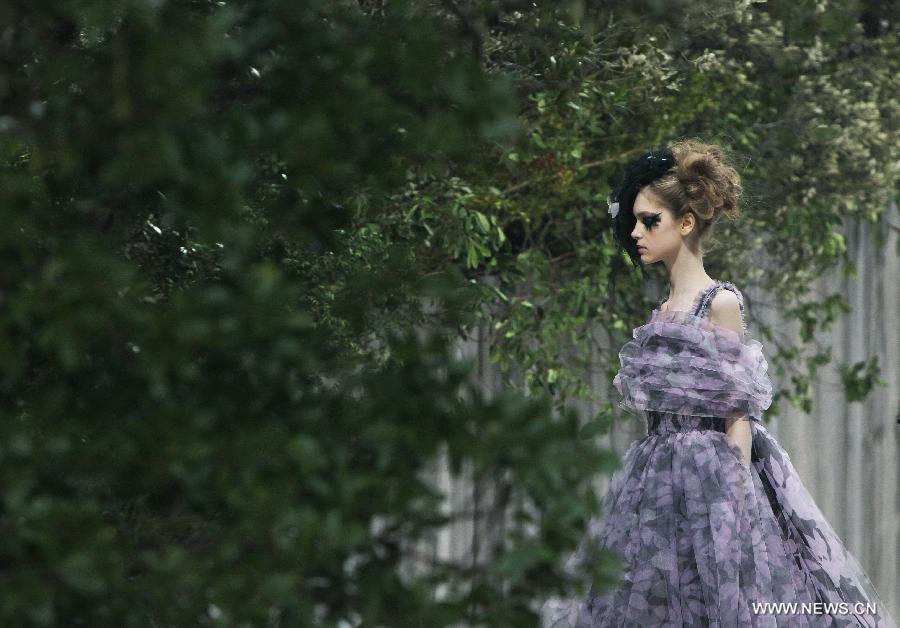 A model presents a creation by German designer Karl Lagerfeld for French fashion house Chanel during the Haute Couture Spring-Summer 2013 collection shows in Paris, France, Jan. 22, 2013. (Xinhua/Gao Jing) 