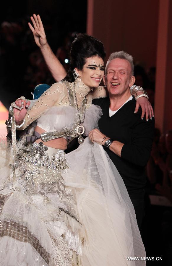 French designer Jean Paul Gaultier (R) acknowledges the public next to a model during the Haute Couture Spring-Summer 2013 collection shows in Paris, France, Jan. 23, 2013. (Xinhua/Gao Jing) 