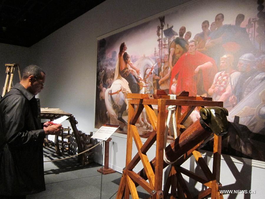 A visitor watches the model of a Rome siege weapon during an exhibition at Hong Kong Science Museum in south China's Hong Kong, Jan. 23, 2013. Exhibition "Julius Caesar - Military Genius and Mighty Machines" is underway at the Hong Kong Science Museum. More than 40 exhibits reflecting the science and technology of ancient Romans were displayed on the show. (Xinhua/Zhao Yusi) 