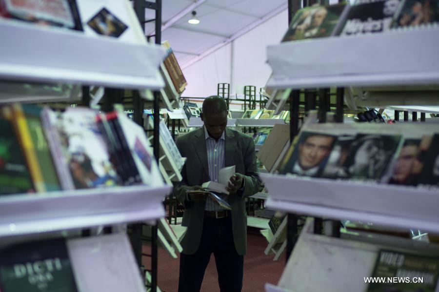 A man reads a book during the 44th Cairo International Book Fair in Cairo, Egypt, Jan. 23, 2013. (Xinhua/Qin Haishi) 