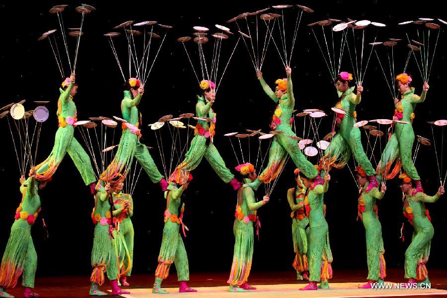Acrobats of the Chinese Acrobatic Troupe perform in Johannesburg, South Africa, Jan. 23, 2013. Twenty-five acrobats of the Chinese Acrobatic Troupe made their debut in Johannesburg on Wednesday night. They are here to attend the celebrations of the 15th anniversary of the establishment of the diplomatic relations between China and South Africa, and also the upcoming Chinese lunar New Year. (Xinhua/Liang Quan) 