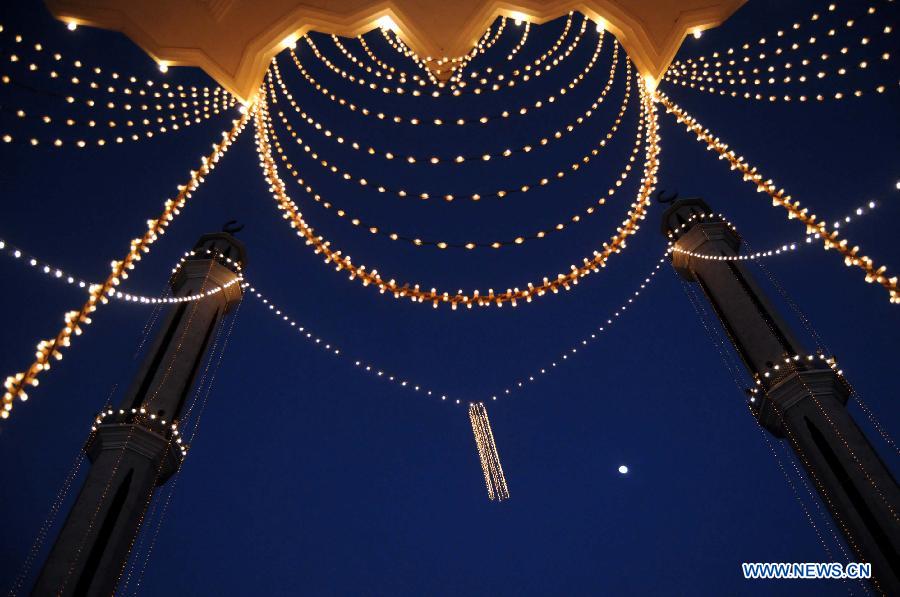 The illuminated mosque is seen during celebrations ahead of Eid-e-Milad-un-Nabi, marking the birth anniversary of the Islam's Prophet Mohammed, in northwest Pakistan's Peshawar on Jan. 24, 2013. (Xinhua Photo/Umar Qayyum)