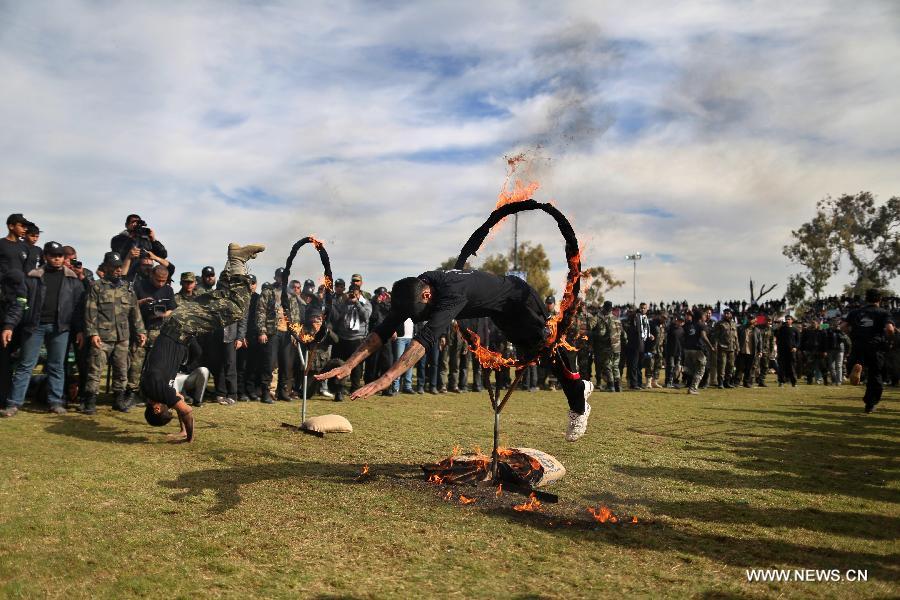 Palestinian high school students show their skills during a graduation ceremony of a military school course organized by the Hamas security forces and the Hamas Minister of Education in Gaza City, on Jan. 24, 2013. (Xinhua/Wissam Nassar)  