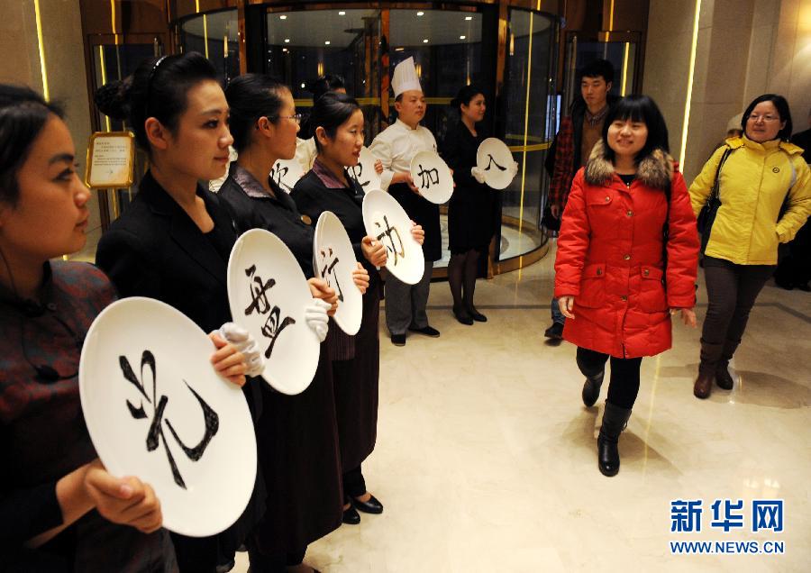 Staff members of a restaurant launch a campaign encouraging consumers to avoid food waste in Qingdao, Shandong province, Jan. 24. Stirred by an exposure on astonishing food waste on Chinese tables, “Did you empty the dishes today?” has become the most popular question in China. As response, restaurants and government departments take actions to eliminate food waste. Showing an empty dish also turns a new fashion among Chinese netizens. (Xinhua/Li Ziheng) 