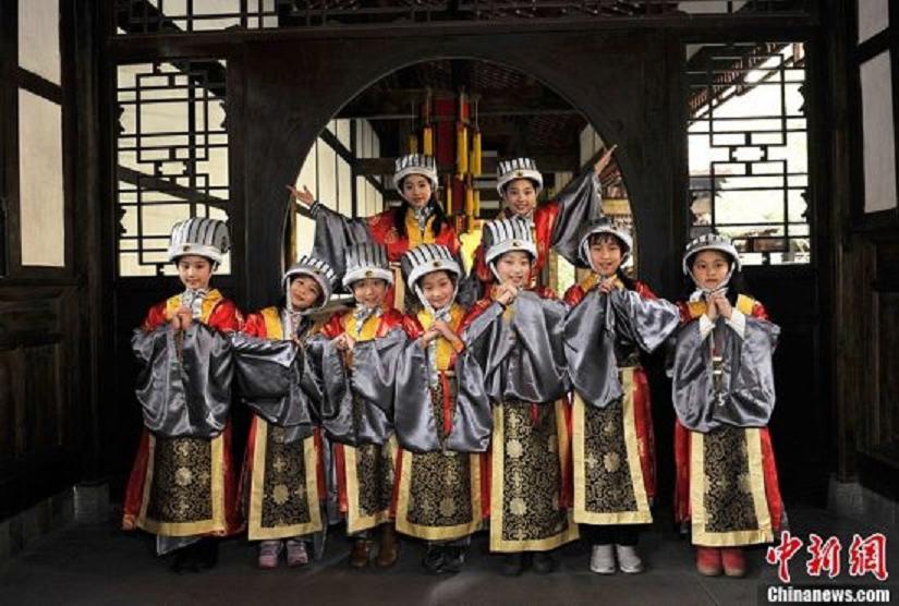 Children in costumes of "God of Happiness" meet the media in the Wuhou Memorial Temple in Chengdu, Sichuan Province, January 24, 2013. They will perform at a temple fair during the Spring Festival.  (Photo: CNS/An Yuan)