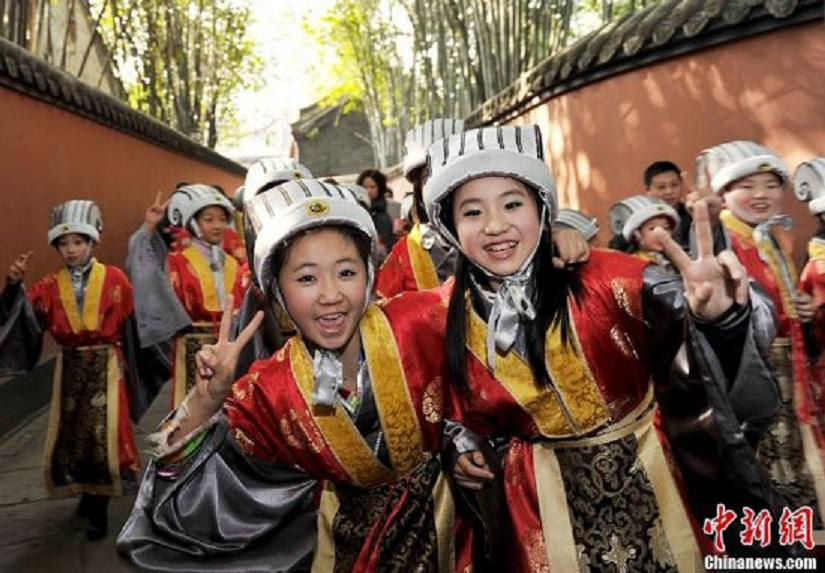 Children in costumes of "God of Happiness" meet the media in the Wuhou Memorial Temple in Chengdu, Sichuan Province, January 24, 2013. They will perform at a temple fair during the Spring Festival.  (Photo: CNS/An Yuan)