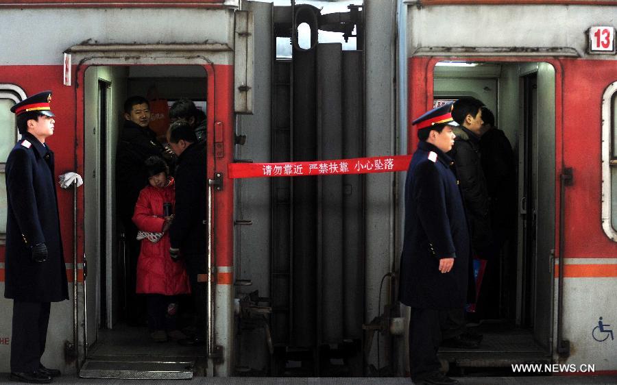 Passengers board a train at the Beijing Railway Station in Beijing, capital of China, Jan. 26, 2013. The 40-day Spring Festival travel rush started on Saturday. The Spring Festival, which falls on Feb. 10 this year, is traditionally the most important holiday of the Chinese people. It is a custom for families to reunite in the holiday, a factor that has led to massive seasonal travel rushes in recent years as more Chinese leave their hometowns to seek work elsewhere. Public transportation is expected to accommodate about 3.41 billion travelers nationwide during the holiday, including 225 million railway passengers, (Xinhua/Gong Lei)  
