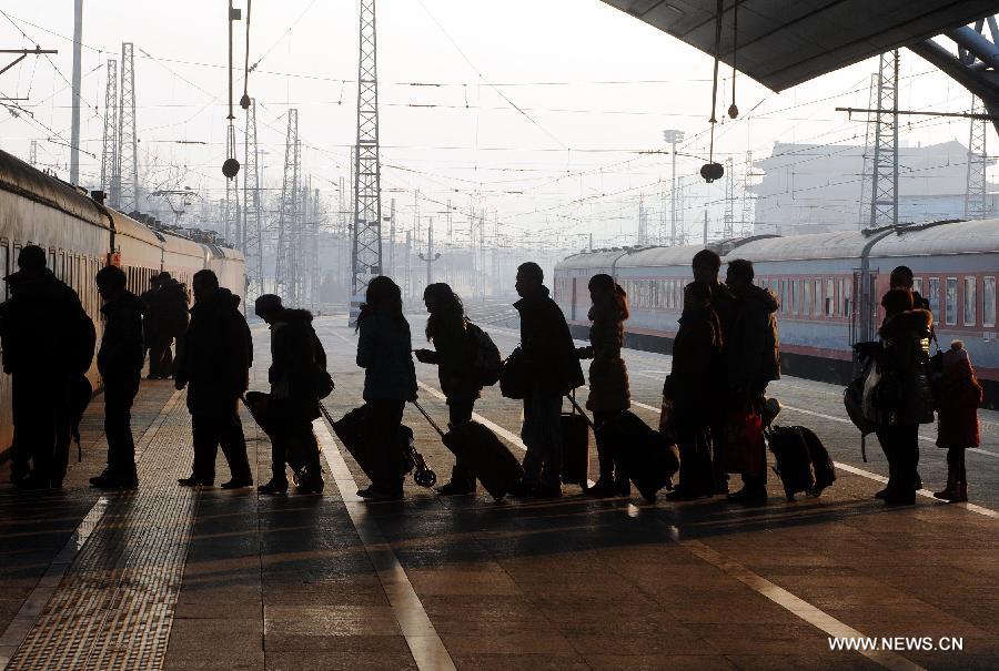 Passengers queue up to board a train at the Beijing Railway Station in Beijing, capital of China, Jan. 26, 2013. The 40-day Spring Festival travel rush started on Saturday. The Spring Festival, which falls on Feb. 10 this year, is traditionally the most important holiday of the Chinese people. It is a custom for families to reunite in the holiday, a factor that has led to massive seasonal travel rushes in recent years as more Chinese leave their hometowns to seek work elsewhere. Public transportation is expected to accommodate about 3.41 billion travelers nationwide during the holiday, including 225 million railway passengers, (Xinhua/Gong Lei)  