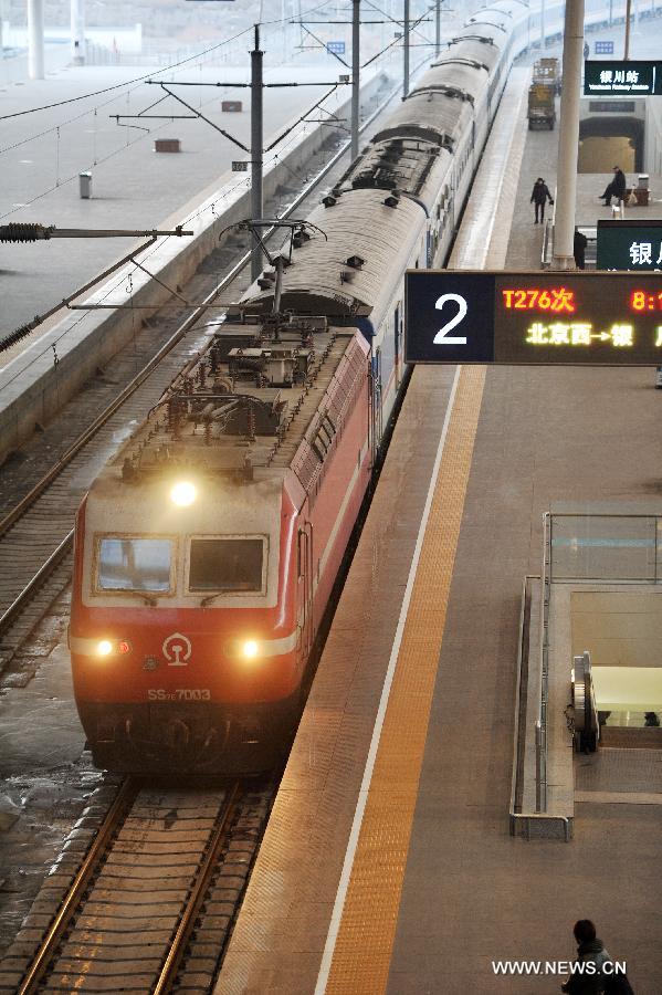 A train from Beijing, capital of China, arrives at the Yinchuan Railway Station in Yinchuan, capital of northwest China's Ningxia Hui Autonomous Region, Jan. 26, 2013. The 40-day Spring Festival travel rush started on Saturday. The Spring Festival, which falls on Feb. 10 this year, is traditionally the most important holiday of the Chinese people. It is a custom for families to reunite in the holiday, a factor that has led to massive seasonal travel rushes in recent years as more Chinese leave their hometowns to seek work elsewhere. Public transportation is expected to accommodate about 3.41 billion travelers nationwide during the holiday, including 225 million railway passengers, (Xinhua/Peng Zhaozhi)