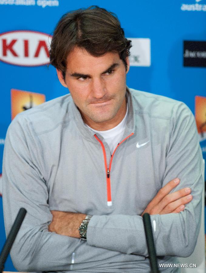Roger Federer of Switzerland reacts during the press conference after the men's singles semifinal match against Andy Murray of Britain at the 2013 Australian Open tennis tournament in Melbourne, Australia, Jan. 25, 2013. Roger Federer lost 2-3. (Xinhua/Bai Xue) 