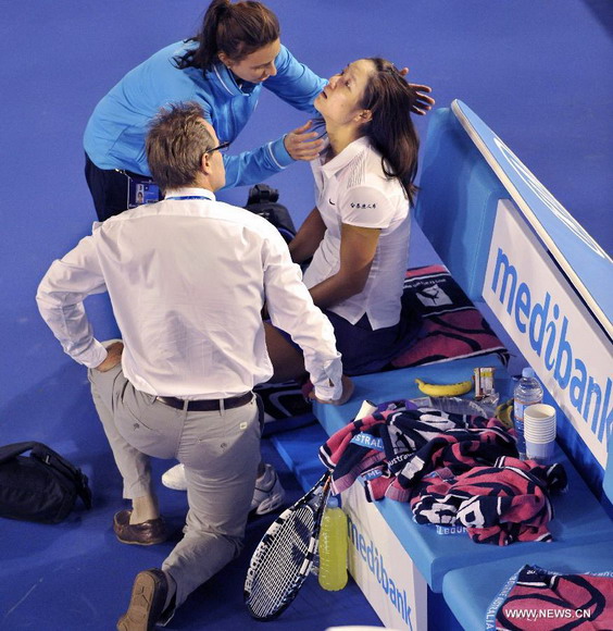 Li Na (2nd L) of China receives treatment from medical staff after falling during the women's singles final match against Victoria Azarenka of Belarus at the 2013 Australian Open tennis tournament in Melbourne, Australia, Jan. 26, 2013. Azarenka won 2-1 to claim the title. (Xinhua/Chen Xiaowei)