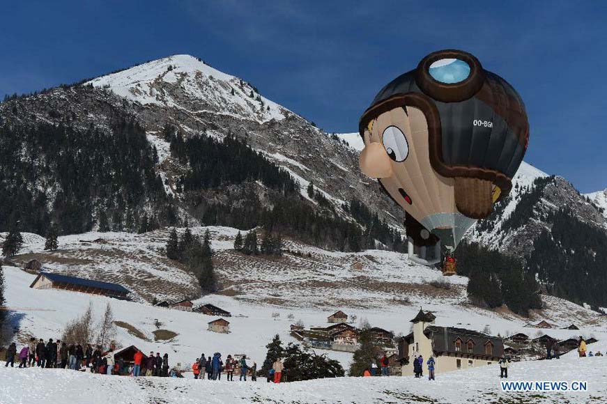 A cartoon balloon takes off at the 35th International Ballon Festival in Chateau-d'Oex, Switzerland, Jan. 26, 2013. The 9-day ballon festival kicked off here on Saturday with the participation of over 80 balloons from 15 countries and regions. (Xinhua/Wang Siwei)