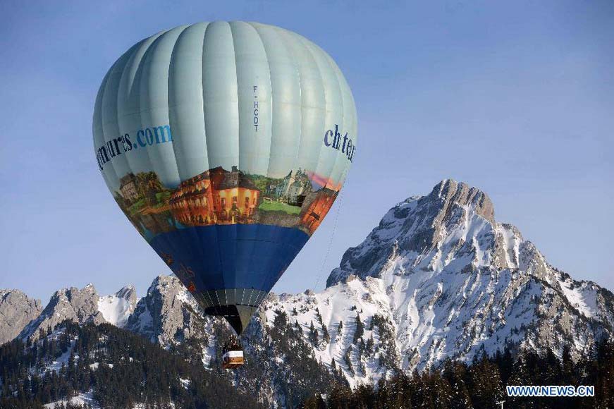 A balloon flies over Chateau-d'Oex, Switzerland, Jan. 26, 2013. The 9-day 35th International Balloon Festival kicked off here on Saturday with the participation of over 80 balloons from 15 countries and regions. (Xinhua/Wang Siwei) 