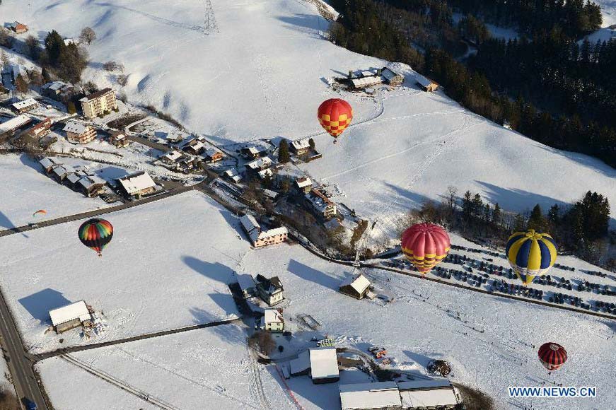 Balloons fly over Chateau-d'Oex, Switzerland, Jan. 26, 2013. The 9-day 35th International Balloon Festival kicked off here on Saturday with the participation of over 80 balloons from 15 countries and regions. (Xinhua/Wang Siwei) 