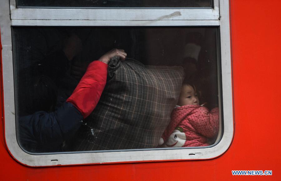 A child looks out of the window of a train at Hangzhou train station in Hangzhou, capital of east China's Zhejiang Province, Jan. 27, 2013. The 40-day Spring Festival travel rush began on Saturday. The Spring Festival, the most important occasion for a family reunion for the Chinese people, falls on the first day of the first month of the traditional Chinese lunar calendar, or Feb. 10 this year. (Xinhua/Han Chuanhao)
