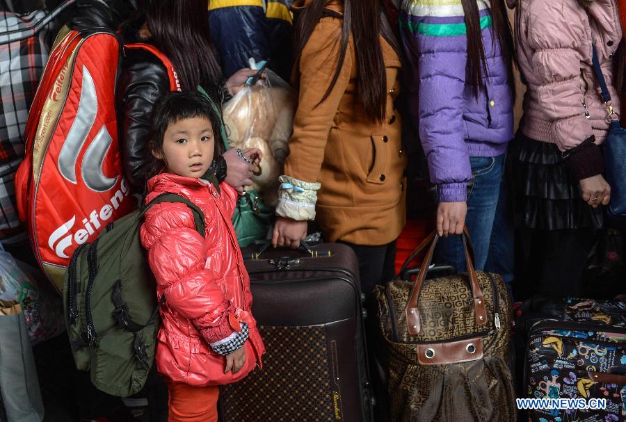 A girl heading for Guiyang, capital of southwest China's Guizhou Province, waits for the train with her family member at Hangzhou train station in Hangzhou, capital of east China's Zhejiang Province, Jan. 27, 2013. The 40-day Spring Festival travel rush began on Saturday. The Spring Festival, the most important occasion for a family reunion for the Chinese people, falls on the first day of the first month of the traditional Chinese lunar calendar, or Feb. 10 this year. (Xinhua/Han Chuanhao)