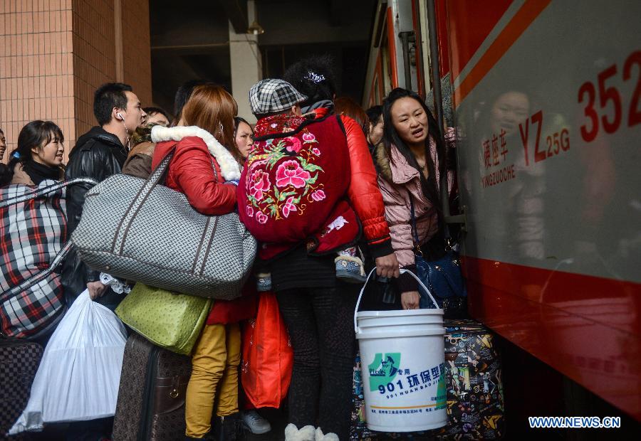Passengers board a train from Hangzhou to Guiyang, capital of southwest China's Guizhou Province, at Hangzhou train station in Hangzhou, capital of east China's Zhejiang Province, Jan. 27, 2013. The 40-day Spring Festival travel rush began on Saturday. The Spring Festival, the most important occasion for a family reunion for the Chinese people, falls on the first day of the first month of the traditional Chinese lunar calendar, or Feb. 10 this year. (Xinhua/Han Chuanhao)