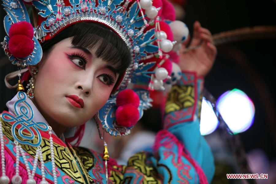 An actress performs Puxian opera, one of the oldest forms of Chinese opera, at the Dongqin Village in Putian City, southeast China's Fujian Province, Jan. 26, 2013. Puxian opera, which originated from puppet shows, has been listed as a national intangible cultural heritage. (Xinhua/Lin Jianbing)