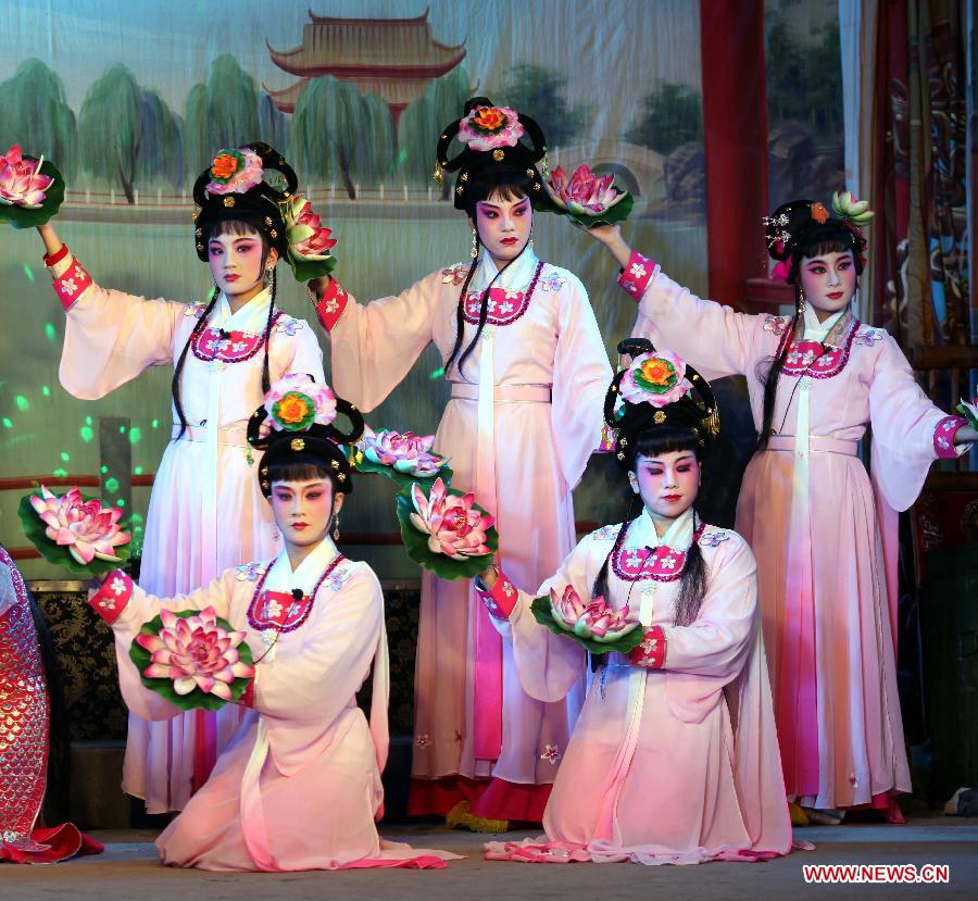 Actresses perform Puxian opera, one of the oldest forms of Chinese opera, at the Dongqin Village in Putian City, southeast China's Fujian Province, Jan. 26, 2013. Puxian opera, which originated from puppet shows, has been listed as a national intangible cultural heritage. (Xinhua/Lin Jianbing)