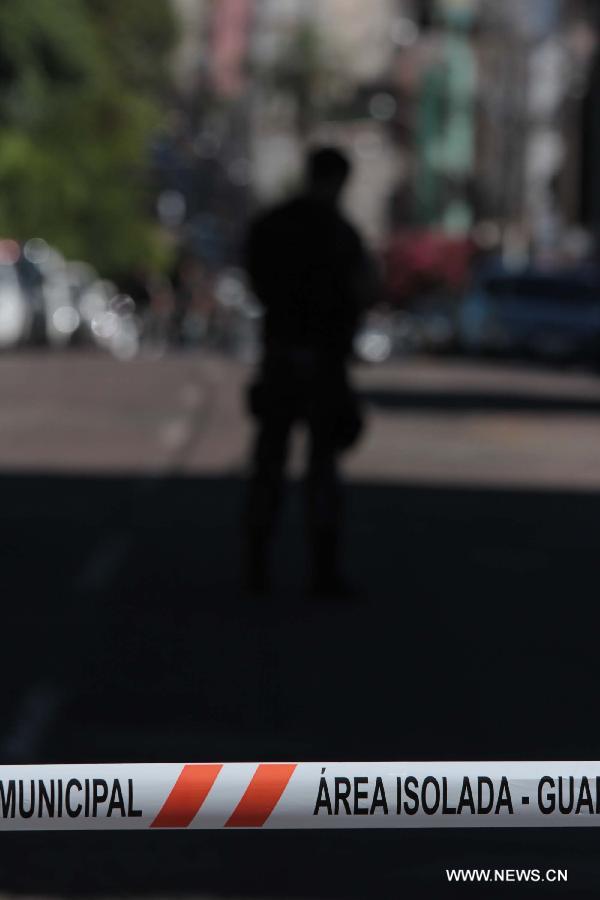 A policeman watches over the municipal sports center to which the bodies of the victims are transfered from the site of a nightclub fire in Santa Maria, state of Rio Grande do Sul, Brazil, on Jan. 27, 2013. A nightclub fire that broke out in Santa Maria, southern Brazil early Sunday killed at least 245 people, according to a local TV report. (Xinhua/AGENCIA ESTADO) 