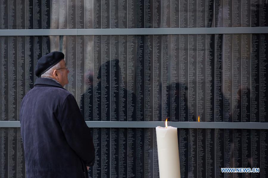 A man stands in front of a memorial wall at Budapest's Holocaust Memorial Centre in Budapest, Hungary, on the international Holocaust Remembrance Day of Jan. 27, 2013. The annual International Day was designated by a UN General Assembly resolution to fall each year on Jan. 27, the anniversary of the liberation of the Auschwitz death camp. (Xinhua/Attila Volgyi) 