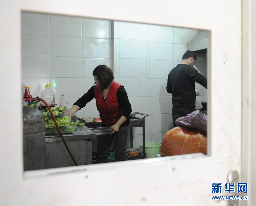 The restaurant owner's wife, Jin Xiaomin(left) and chef prepare pasta in the kitchen on Jan. 25, 2013.