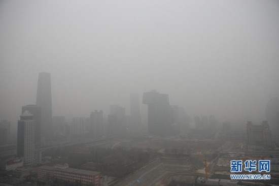 A photo taken on Jan. 13 shows the foggy landscape of the Beijing Central Business District. Beijing's meteorological center on Monday issued a yellow-coded alert for haze as the fourth foggy weather in this month hit the city and cuts the visibility below 3,000 meters in major parts of Beijing. (Photo/Xinhua)