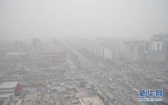A photo taken on Jan. 13 shows the bird’s-eye view of Beijing’s Xicheng District. Beijing's meteorological center on Monday issued a yellow-coded alert for haze as the fourth foggy weather in this month hit the city and cuts the visibility below 3,000 meters in major parts of Beijing. (Photo/Xinhua)