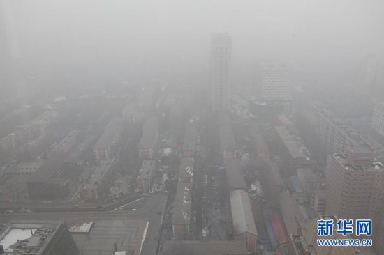 A photo taken on Jan. 23 shows the foggy landscape of the Central Business District in Beijing. Beijing's meteorological center on Monday issued a yellow-coded alert for haze as the fourth foggy weather in this month hit the city and cuts the visibility below 3,000 meters in major parts of Beijing. (Photo/Xinhua)