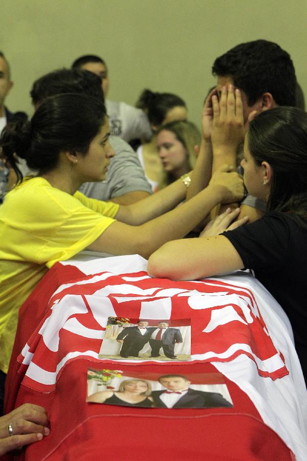 People mourn the dead at the Santa Maria Municipal Sports Center, in Santa Maria, Brazil, on Jan. 28, 2013.  (Xinhua/AGENCIA ESTADO) 