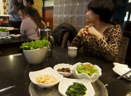 Restaurants in Beijing have agreed to size down their food portions and offer discounts to customers who help save waste in a scheme launched by the city's authorities and catering guild. Some 749 restaurants operated by 10 catering enterprises in the capital will now serve half-portions, half-priced items and assorted dishes. The 10 catering enterprises include China Quanjude Group, xiabu xiabu, Bejing Bianyifang Roast Duck Group, Donglaishun Muslim Restaurant, XE Flavour and Han Na Shan Korean BBQ, pictured here on Jan 27, 2013. (Photo/Xinhua)