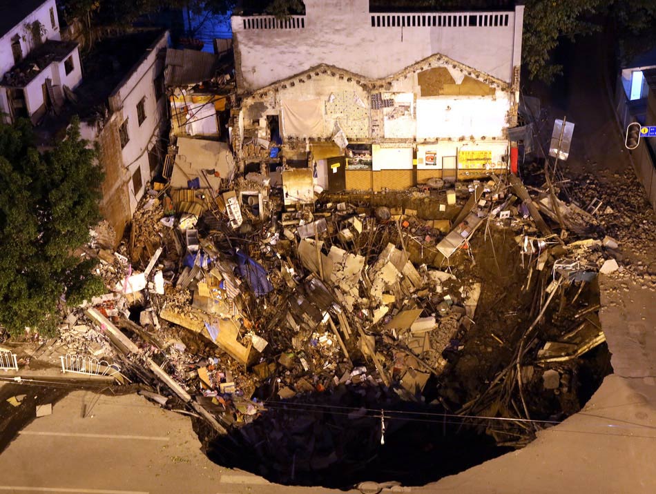 Several buildings collapsed on Monday afternoon after a subsidence at a road junction in Liwan district of downtown Guangzhou. The subsidence occurred again at around 9 p.m. (Photo/Image China)