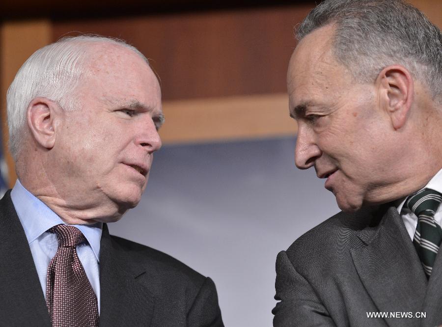 U.S. Senators John McCain (left, R-AZ) and Charles Schumer (D-NY) chat during a press conference on bipartisan framework for comprehensive immigration reform on Capitol Hill, in Washington D.C., capital of the United States, Jan. 28, 2013. (Xinhua/Zhang Jun) 
