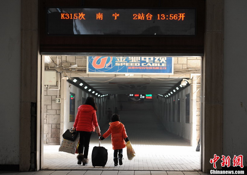 A long journey to home: A mother and her daughter run to catch up the train at Changshang Railway station on Jan. 26, 2013. (CNS/Yang Hufeng)