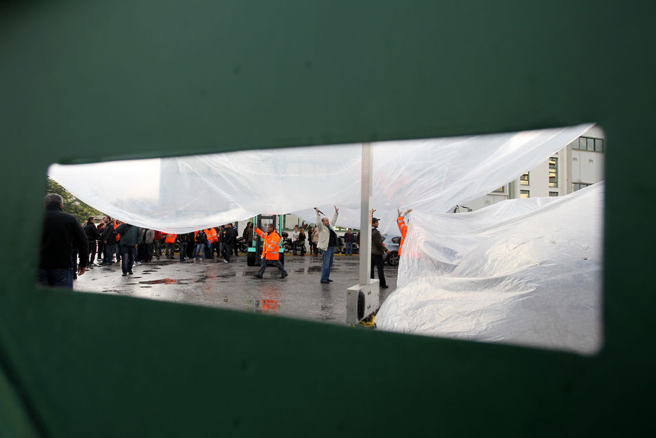 Athens metro employees on strike peer out from the network's headquarters in Athens, Greece on Jan. 24, 2013. (Xinhua/AFP)