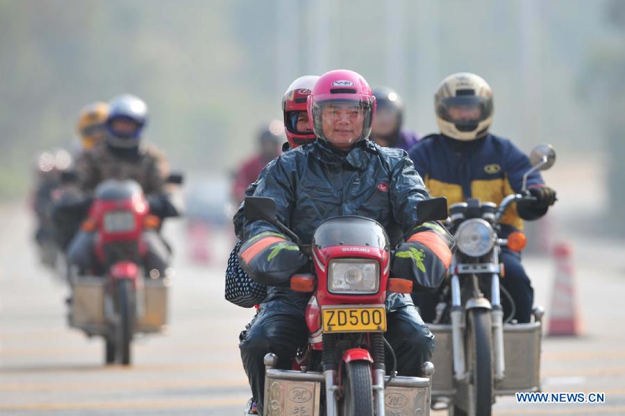 Migrant workers ride motorbikes on their way back home on the 321 National Highway in Wuzhou, south China's Guangxi Zhuang Autonomous Region, Jan. 29, 2013. Many Guangxi migrant workers working in south China's Guangdong Province got around the ticket buying predicament during the Spring Festival travel rush which lasts for forty days by riding back home thanks to the well-developed roads connecting Guangxi and Guangdong. (Xinhua/Huang Xiaobang) 