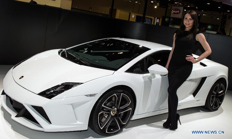 A model presents a Gallardo L560-4 Lamborghini car during the 3rd Qatar International Auto Show held in Doha Exhibition Center, Qatar, on Jan. 28, 2013. The six-day Auto Show kicked off here on Monday. (Xinhua/Chen Shaojin)
