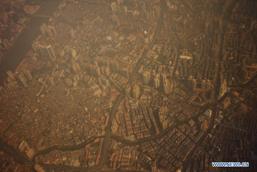 The aerial photo taken on Jan. 29, 2013 shows the smog-covered downtown Guangzhou, capital of south China's Guangdong Province. Guangzhou's local meteorological authorities forecasted on Tuesday that smog would still shroud the city for three days to come. (Xinhua/Wang Shen)