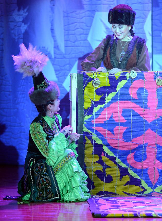 Actors perform in stage play Snowland Families in Altay, northwest China's Xinjiang Uygur Autonomous Region, Jan. 29, 2013. The stage play, created and performed by Altay Art Troupe, tells stories along the ancient Silk Road. (Xinhua/Sadat)