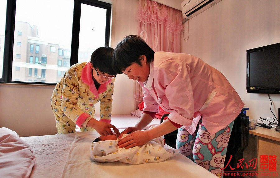 Zhang dries the baby after the bath.