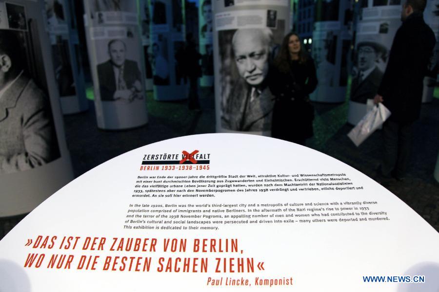 Visitors view the "Diversity Destroyed, Berlin 1933, 1938, 1945" outdoor exhibition in Berlin, Germany, Jan. 29, 2013. The exhibition features portraits of prominent figures in the field of science, artistic and cultural sphere, who were prosecuted by and suffered from the Nazi regime's cruelty dated back to 1933 until 1945. Berlin Municipality kicks off a series of exhibitions, to remind of the 80th anniversary of Adolf Hitler's usurpation of German power on January 30, 1933. (Xinhua/Pan Xu)