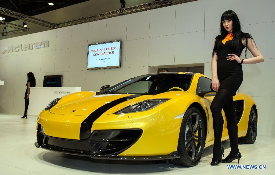 A model presents a McLaren Mp4-12C car during the 3rd Qatar International Auto Show held in Doha Exhibition Center, Qatar, on Jan. 28, 2013. The six-day Auto Show kicked off here on Monday. (Xinhua/Chen Shaojin)